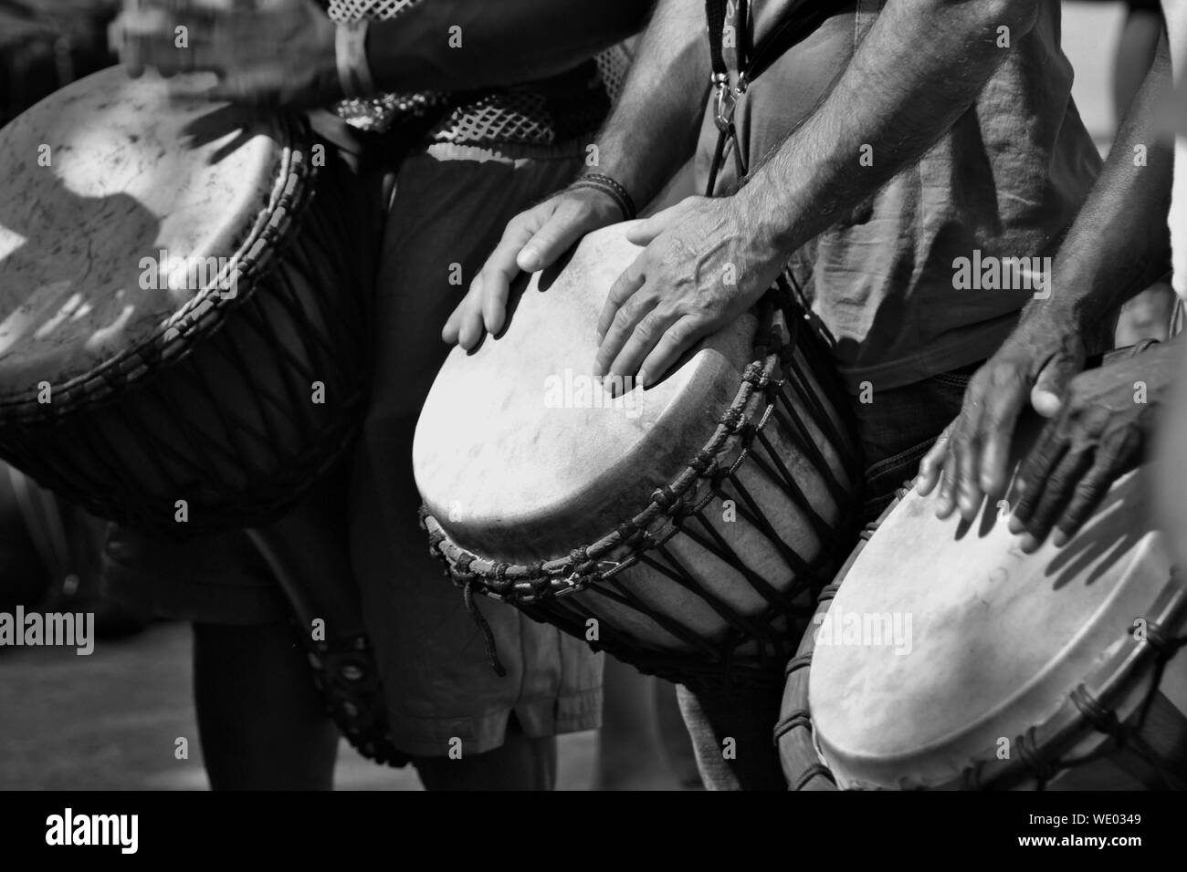 Midsection Of Men Playing Drums Stock Photo