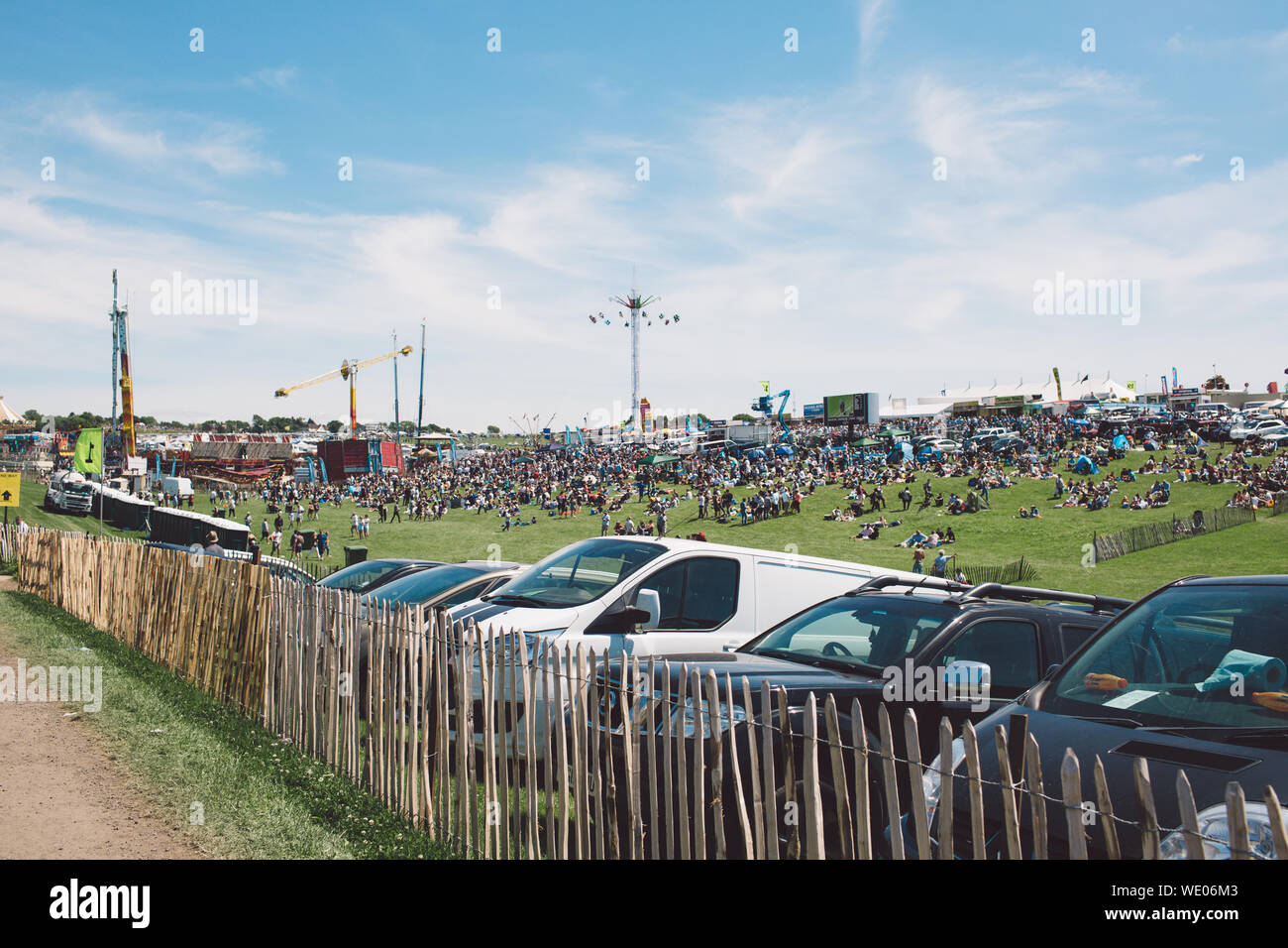 Cars Parked By Fence At Epsom Downs Racecourse Against Sky Stock Photo