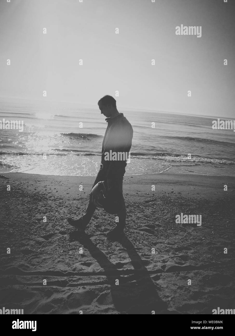 Man Walking Side View Sunlight Black and White Stock Photos & Images ...