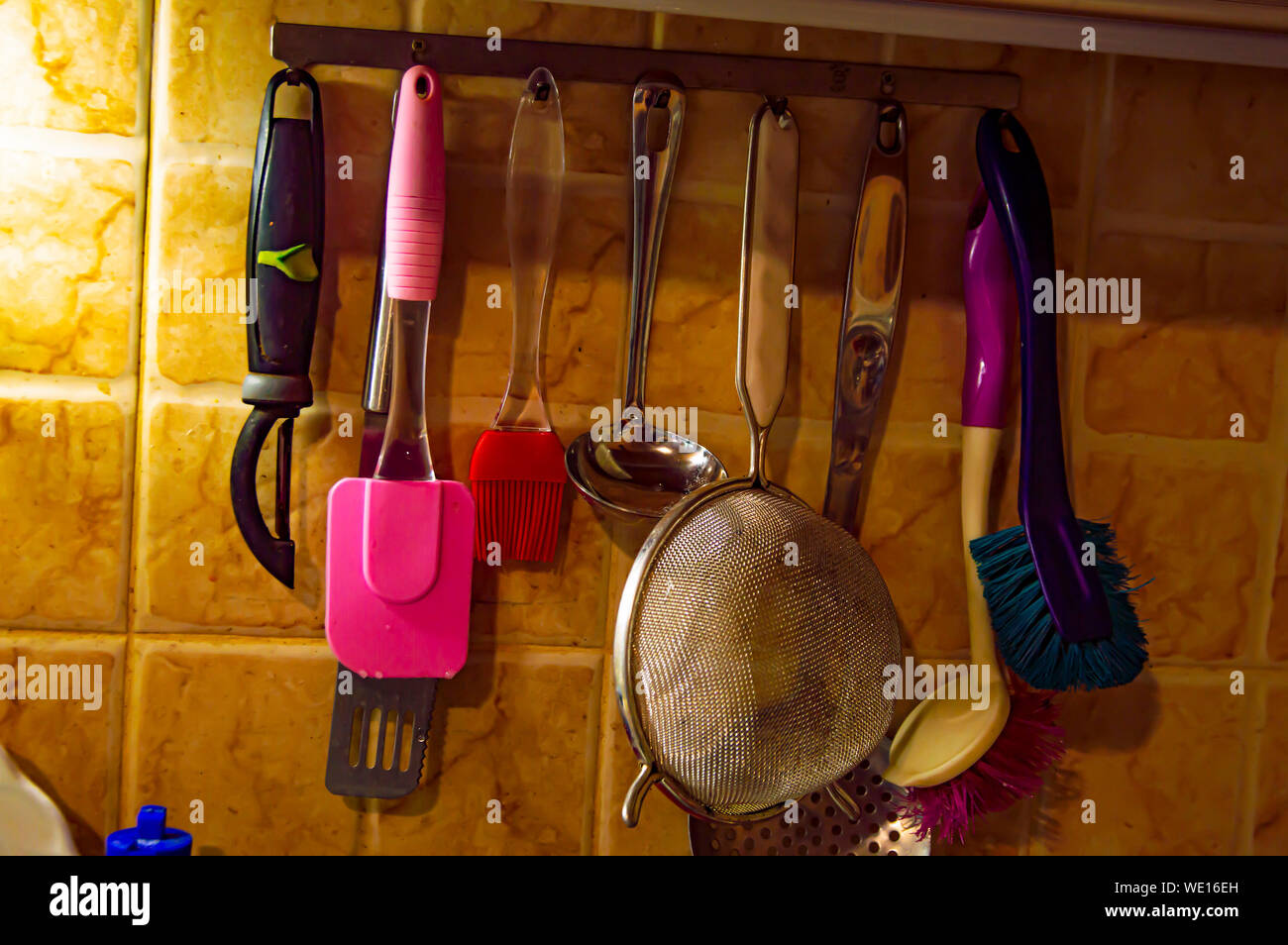 Kitchen tool hanging on the wall. Background image. Place for text. Stock Photo