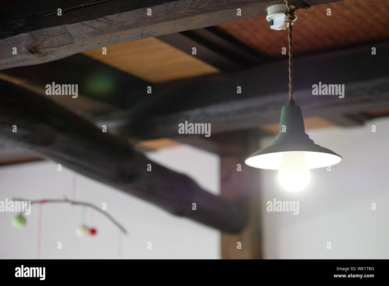 Low Angle View Of Illuminated Lamp Hanging On Ceiling In