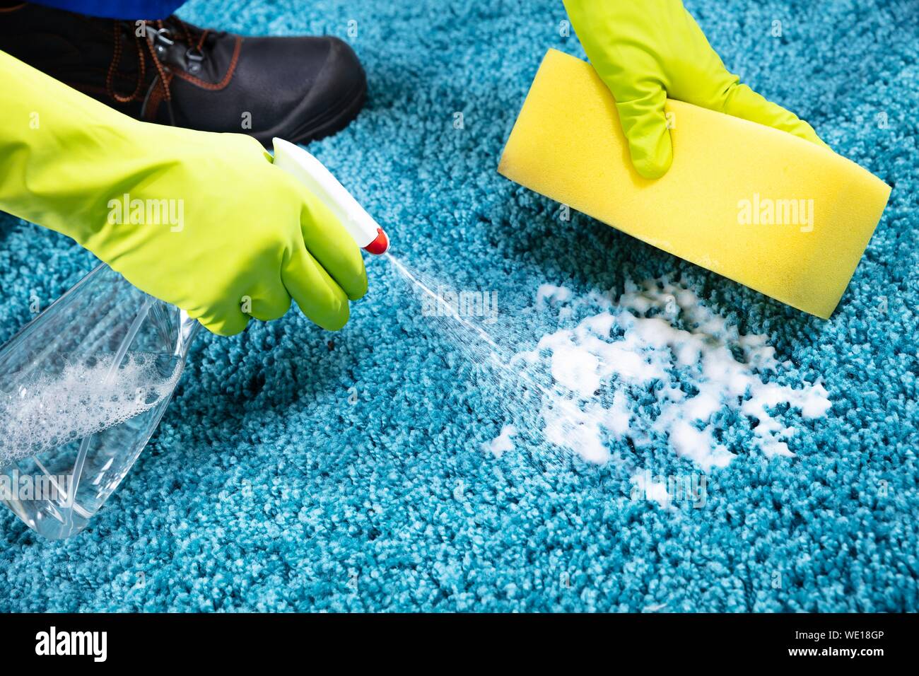 Cropped Hands Cleaning Rug With Soap Foam At Home Stock Photo