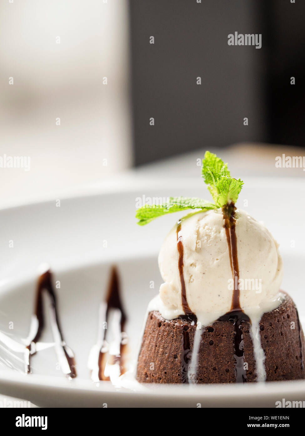 Close-up Of Ice Cream And Brownie With Chocolate Icing Served In Plate Stock Photo