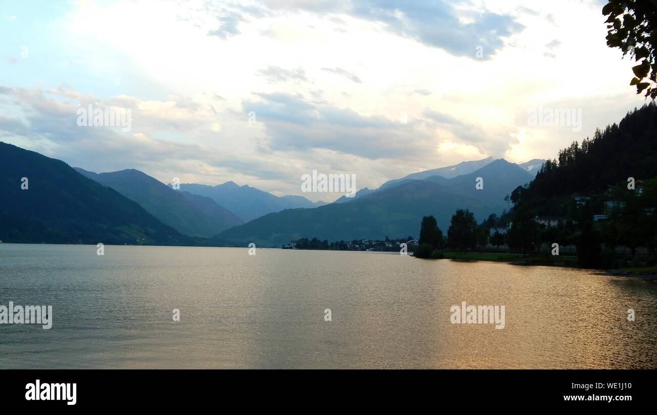 Scenic View Of Lake By Mountains Against Sky Stock Photo