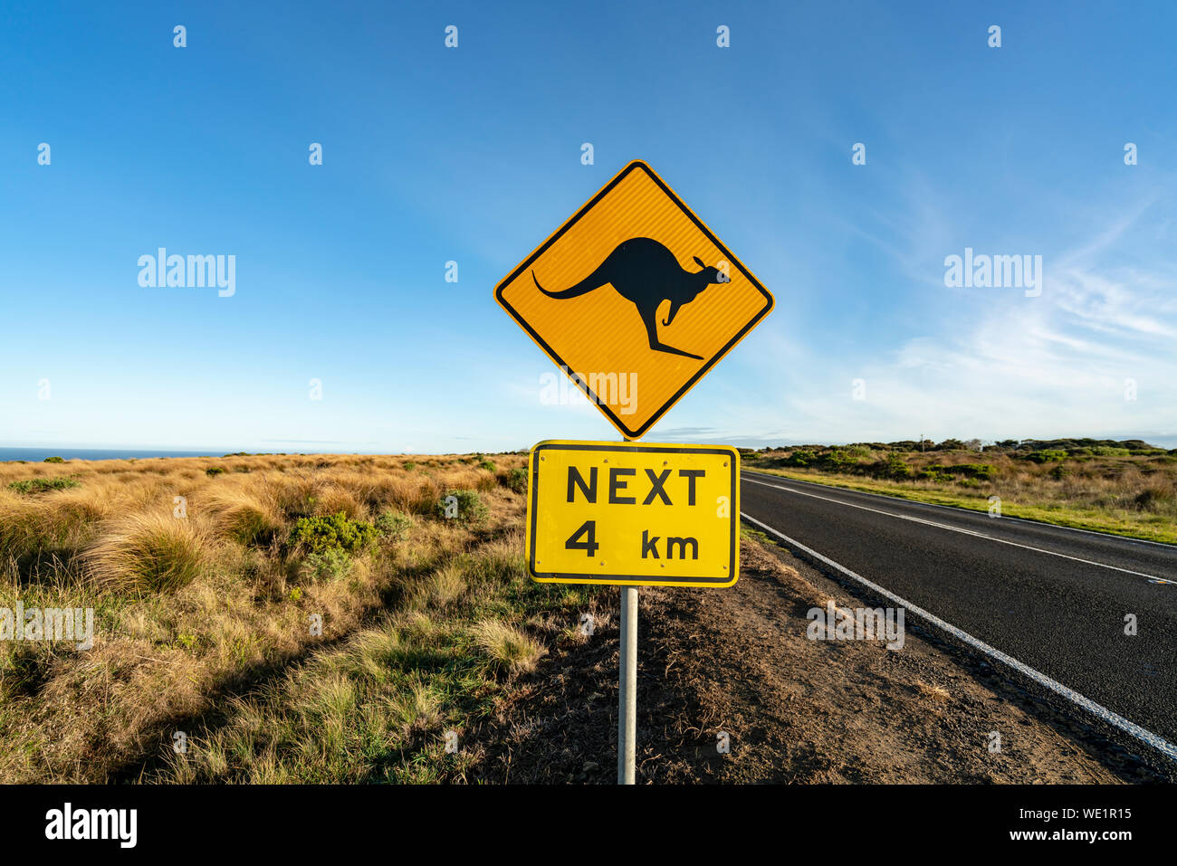 An iconic kangaroo road sign against a blue sky on the Great Ocean Road in Victoria, Australia Stock Photo