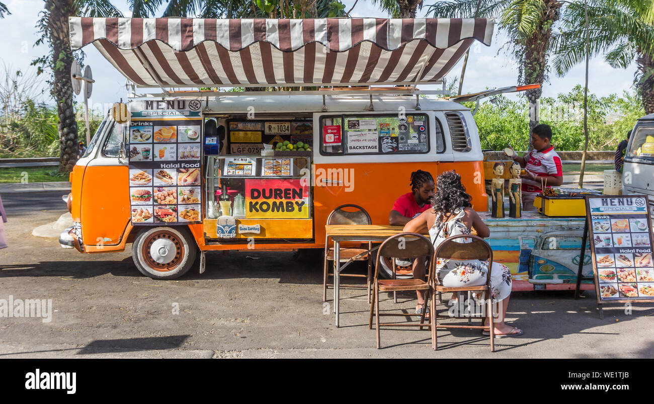 Food truck in a classic orange volkswagen van at the Garuda Wisnu Kencana Cultural Park Stock Photo