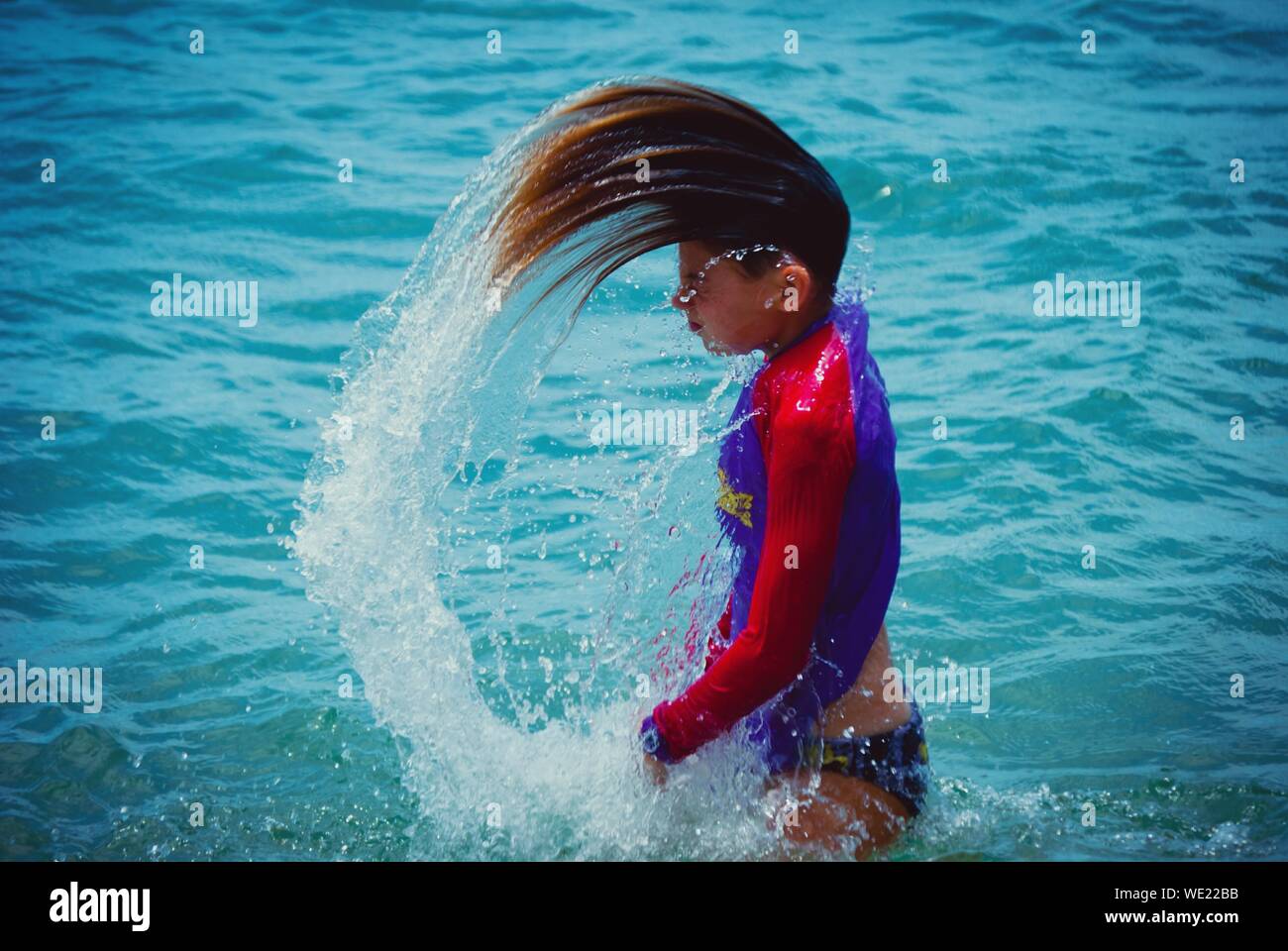 Girl In Sea Throwing Head Back Stock Photo Alamy