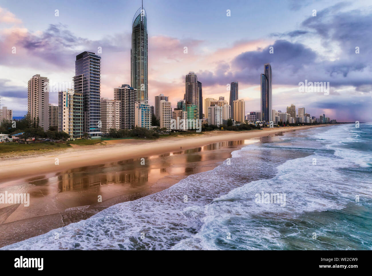 Colourful sunrise over high-rise towers of Surfers Paradise in Australian Gold Coast of Pacific ocean, QUeensland. ELevated aerial view from open sea Stock Photo