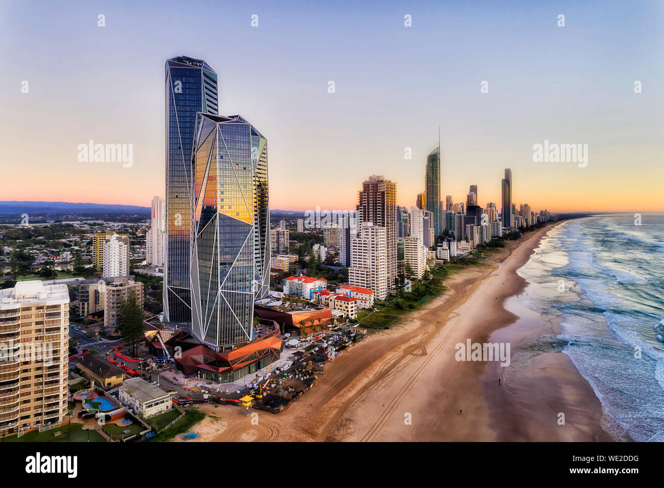 Reflecting facets of modern urban high-rise towers on Australian Gold Coast in Queensland - Surfers Paradise. Wide sandy long beach of Pacific shore a Stock Photo