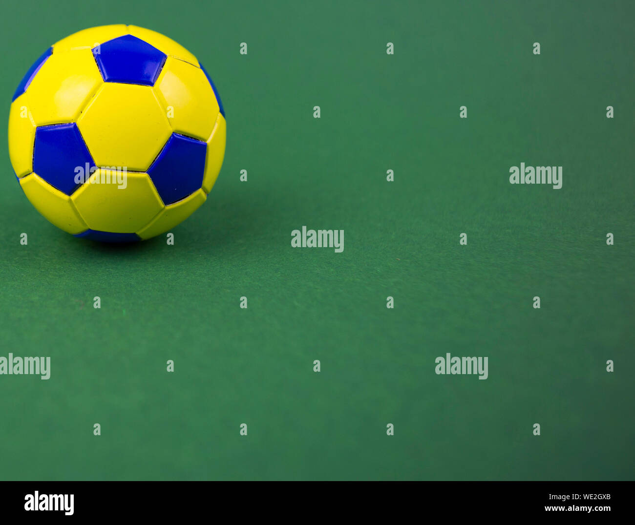 soccer ball on a green background, yellow-blue diamonds, with space for ...