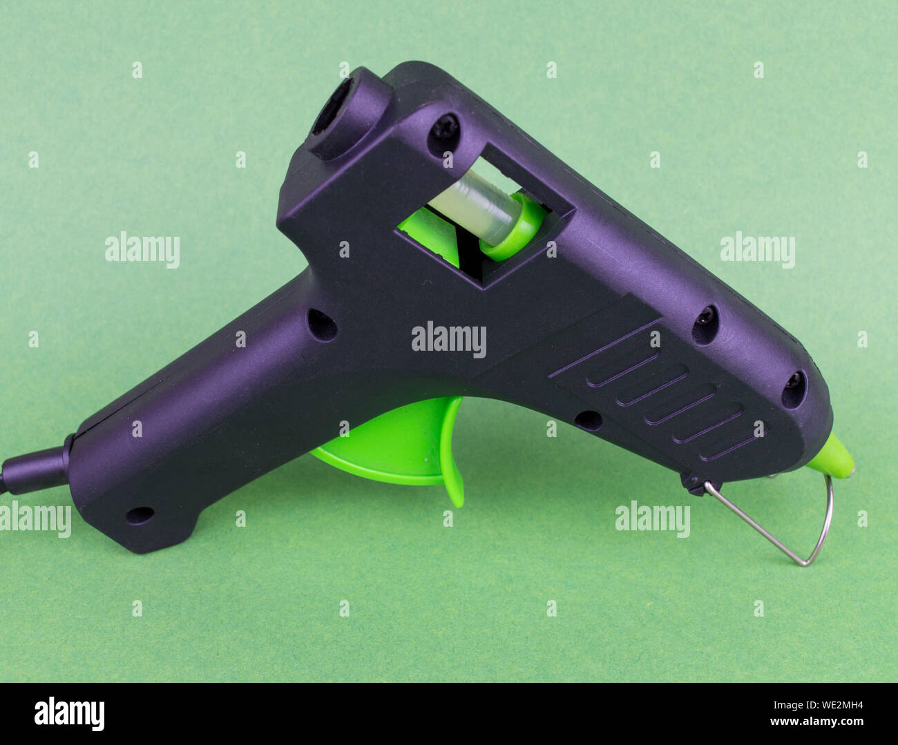 Hot melt gun for plastic soldering on a green background black with a