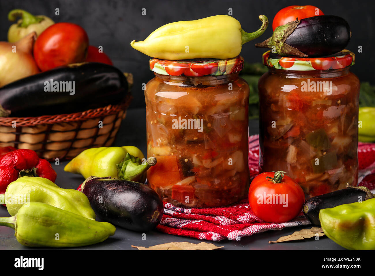 Vegetable salad with peppers, eggplant, onions and tomatoes in jars on
