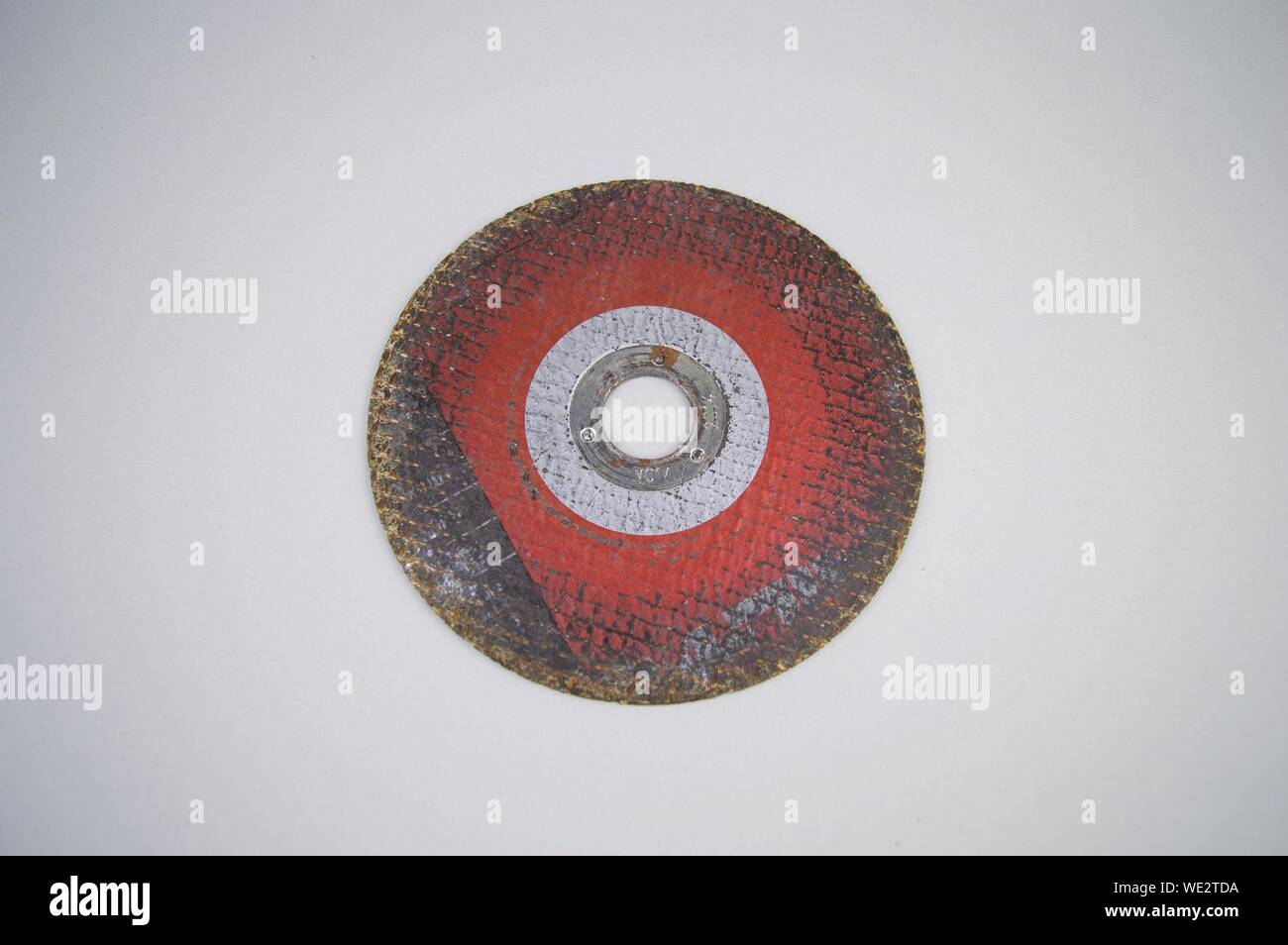 Grinding disc on a gray background with empty space for text. Stock Photo