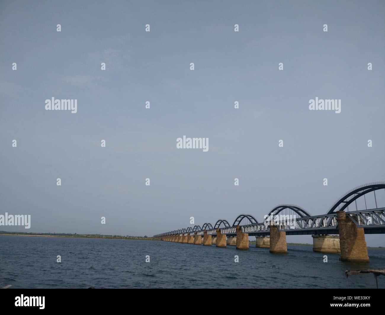 Bridge Over Sea Against Sky Stock Photo
