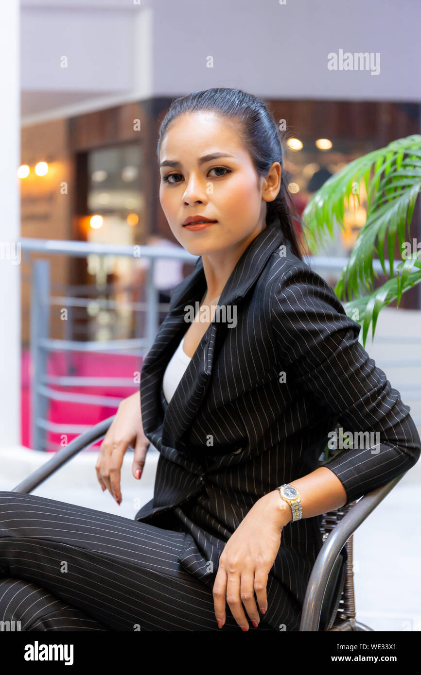 Asian Beautiful business woman sit on the chair Stock Photo