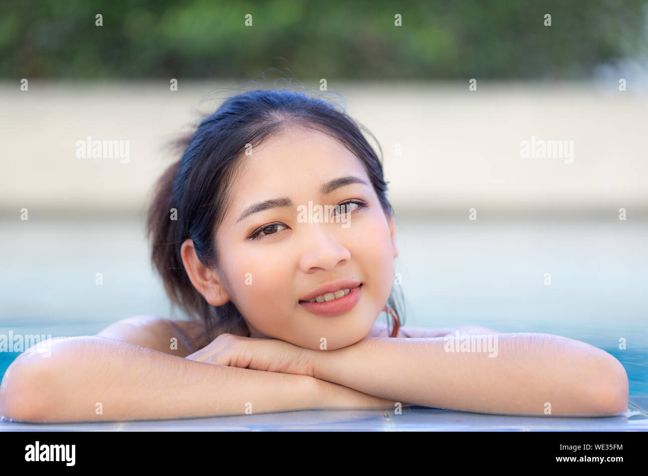 Cute girl in the swimsuite in the pool Stock Photo