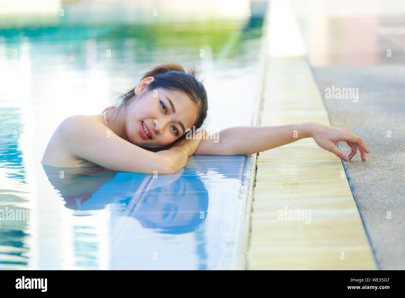 Cute girl in the swimsuite in the pool Stock Photo