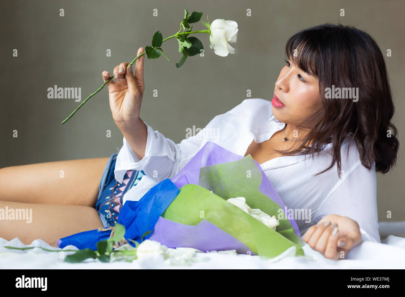 The girl with the flower in her room Stock Photo