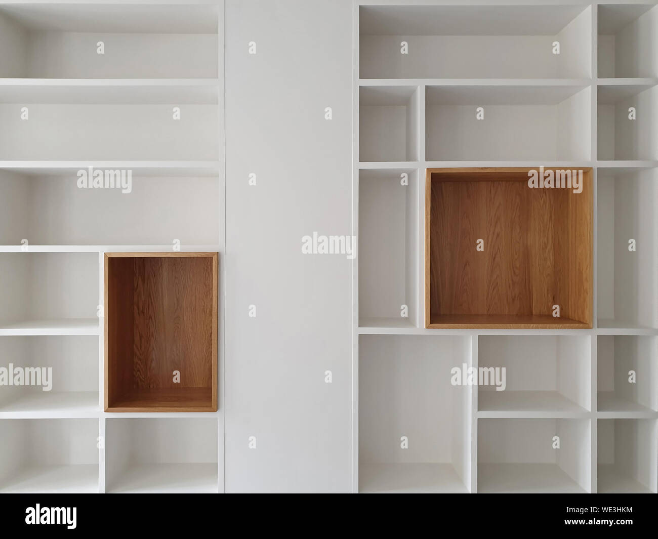 Empty closet shelves background. Modern wooden wardrobe boxes, beautiful white and brown interior design combination, abstract shape and patterns. Stock Photo