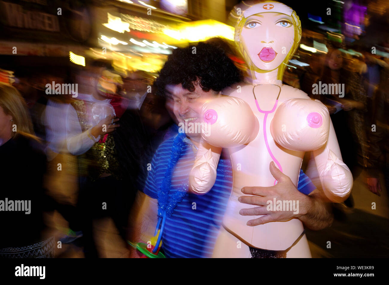 A man carrying a blow up doll, on halloween, Leicester Square, London, Britain. Stock Photo