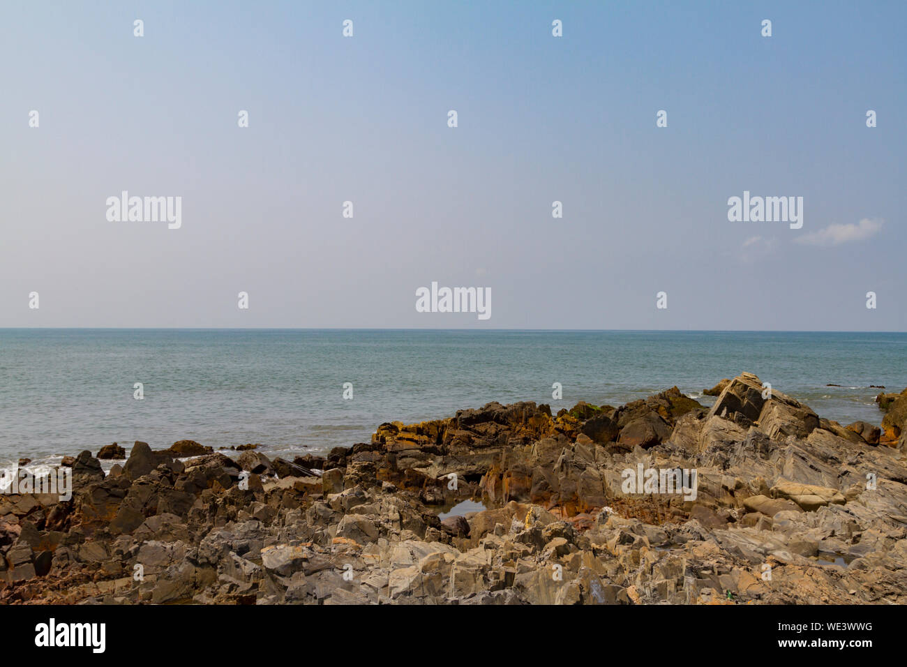 Rocky shore with blue sea and mist on the ocean. Natural landscape ...