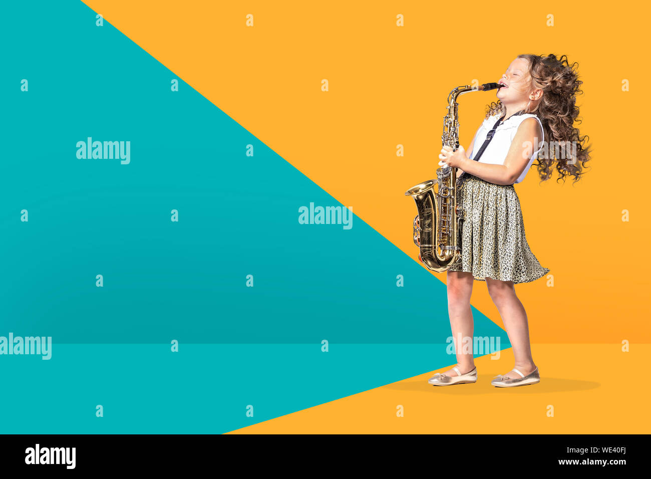 portrait of young girl with a saxophon on the stage Stock Photo