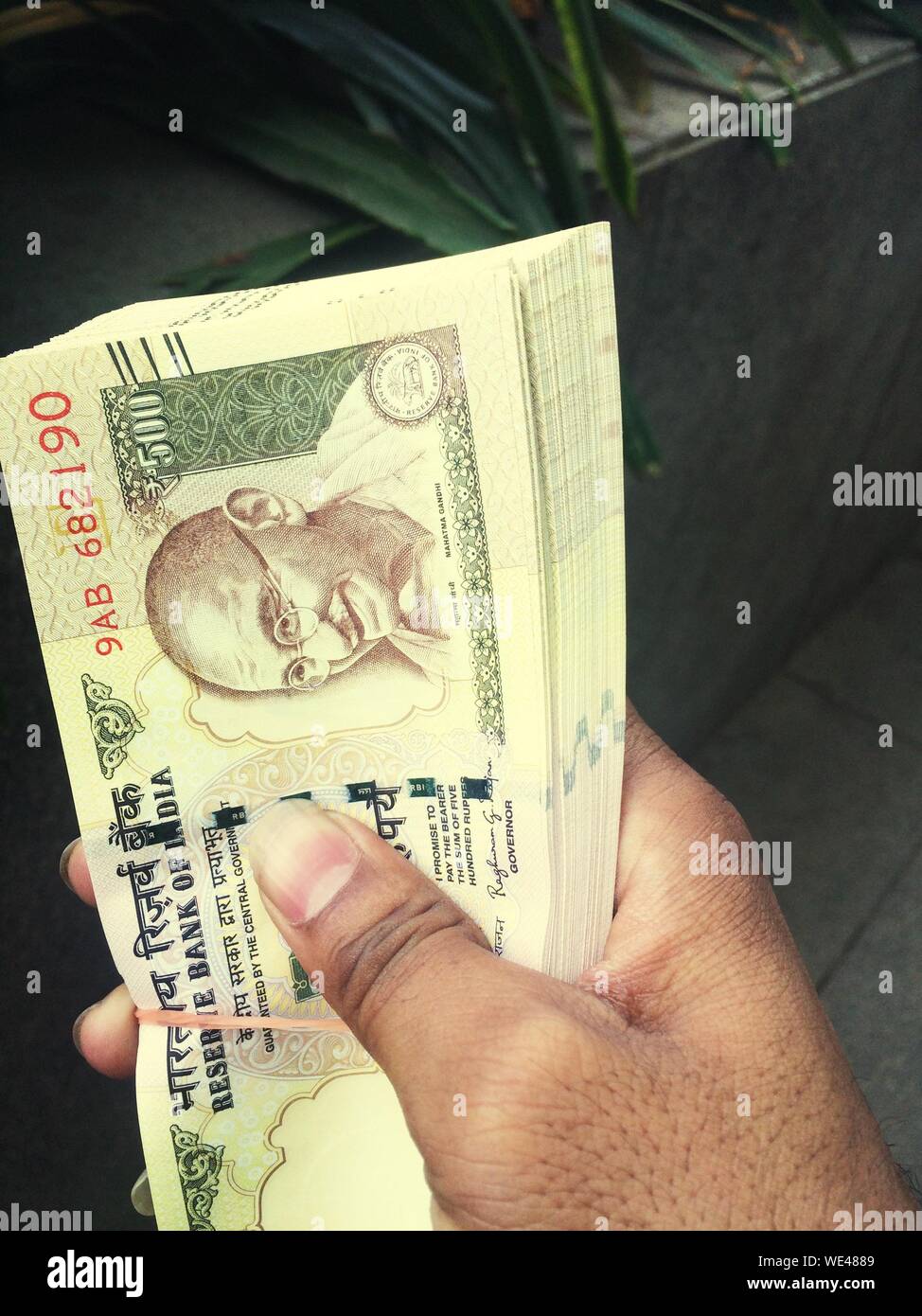 Close-up Of Human Hand Holding Paper Money Stock Photo