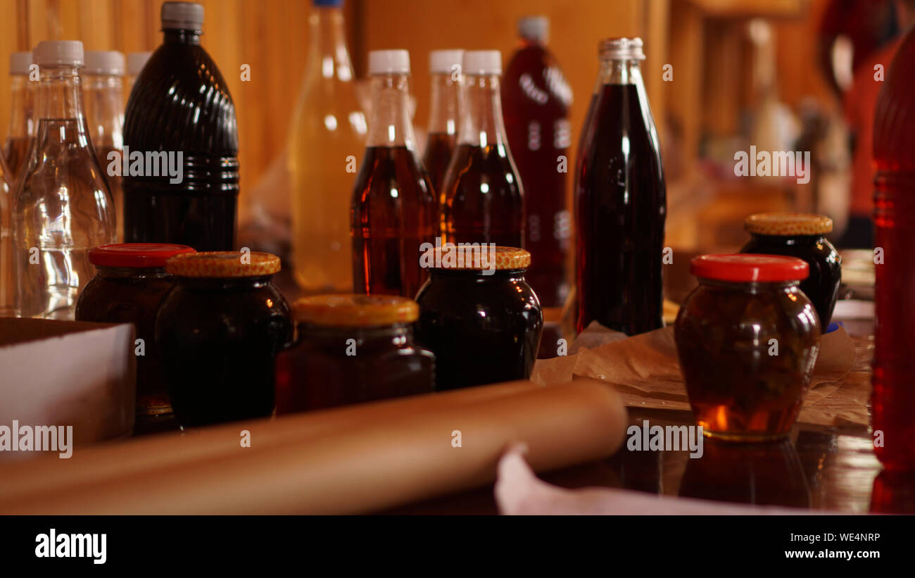 Homemade mead bottles on the shelf of an outdoor market. honey wine
