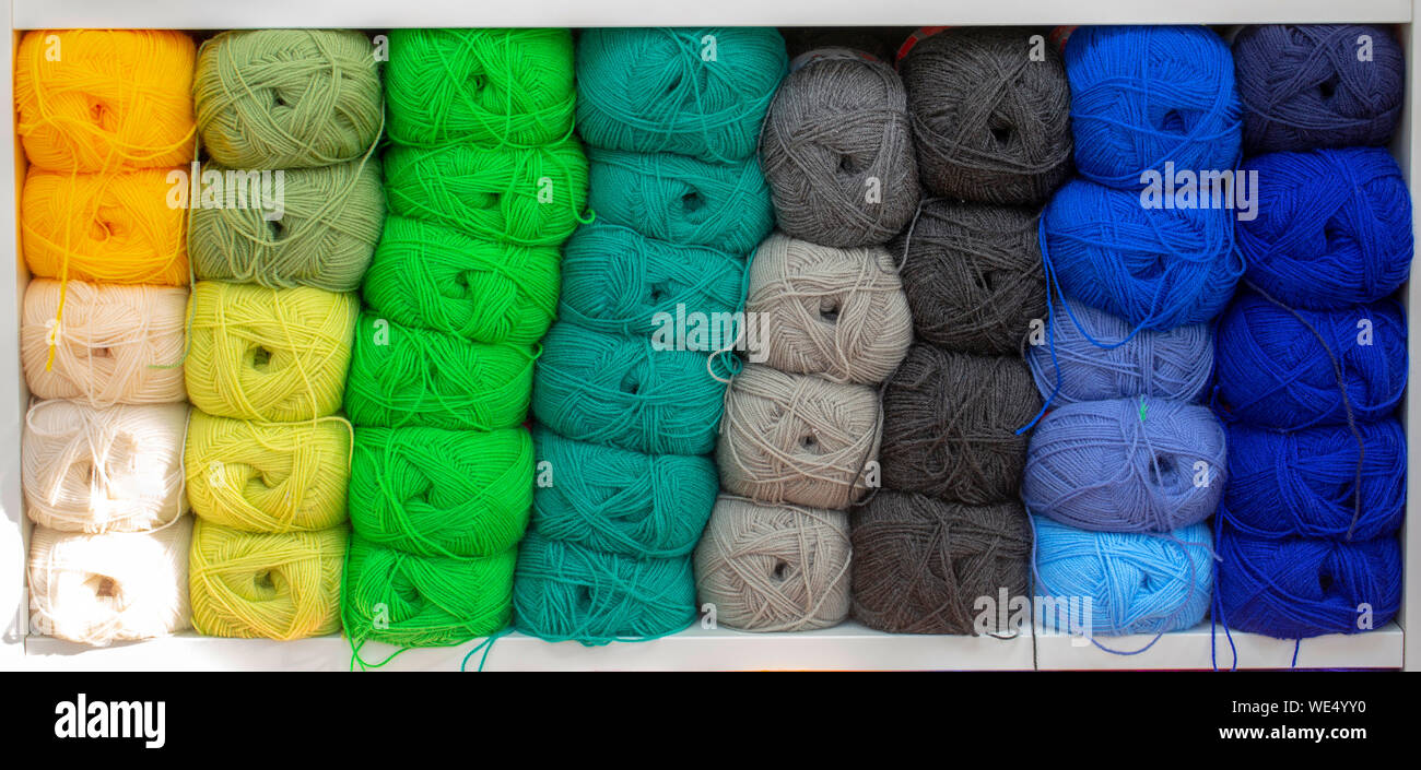 Colorful yarns for sewing on the shelf. Skeins of yarn concept Stock