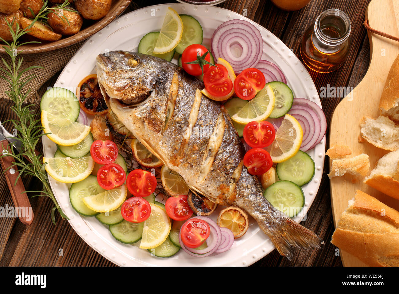 Roast Dorada on a wooden background Stock Photo