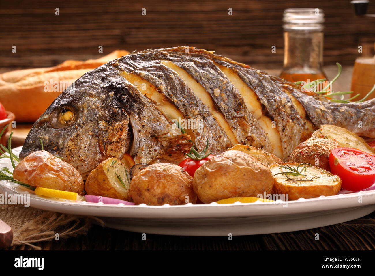 Roast Dorada on a wooden background Stock Photo