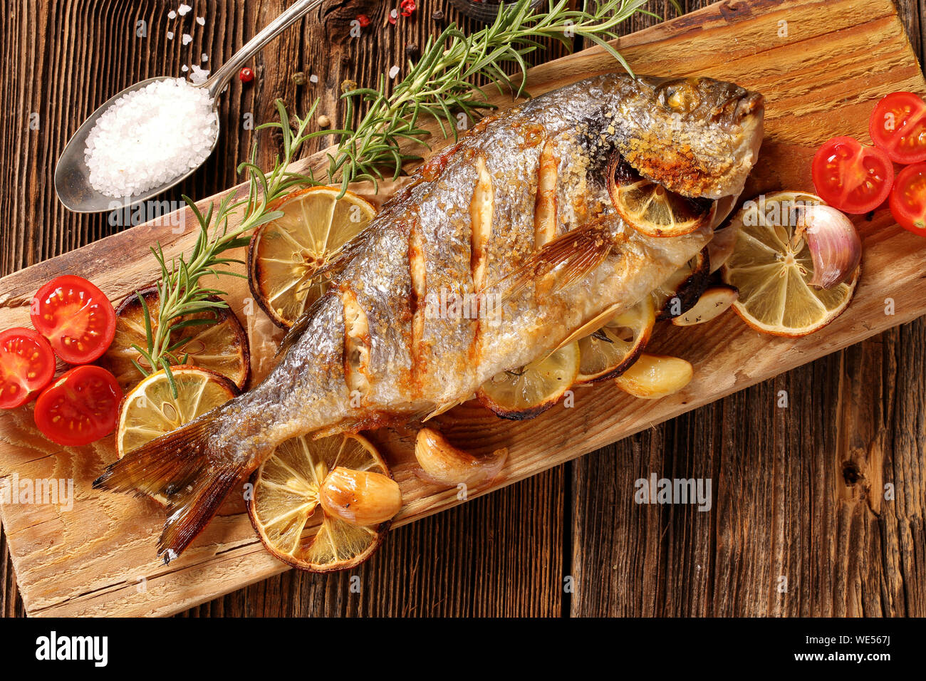 Roast Dorada on a wooden background Stock Photo