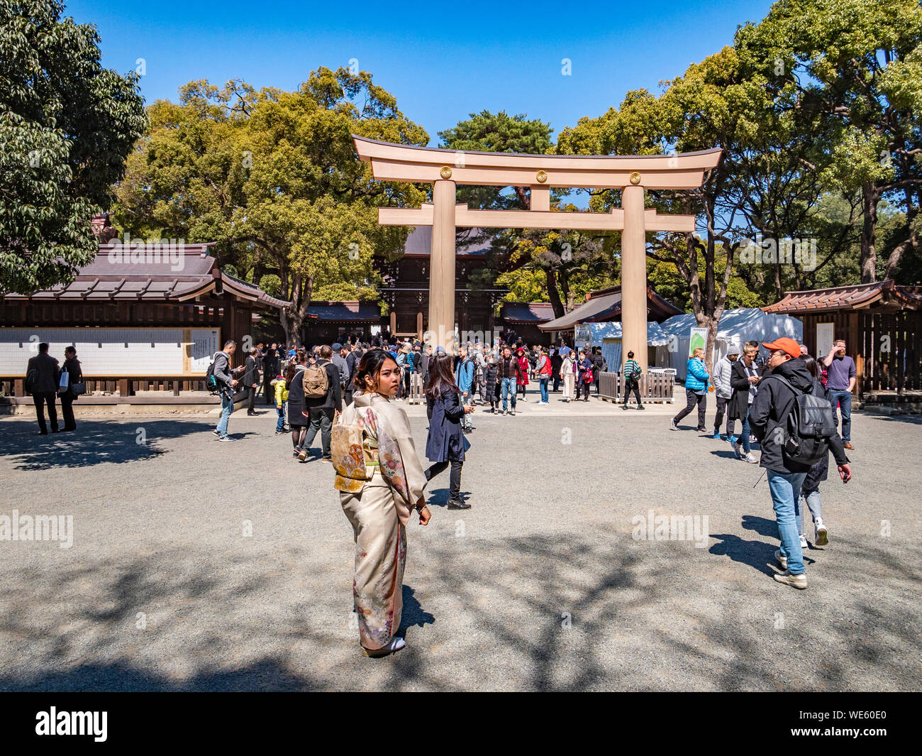 24 March 2019: Tokyo, Japan - Visitors approaching the gate of the Meiji Jingu shrine in Tokyo. Stock Photo
