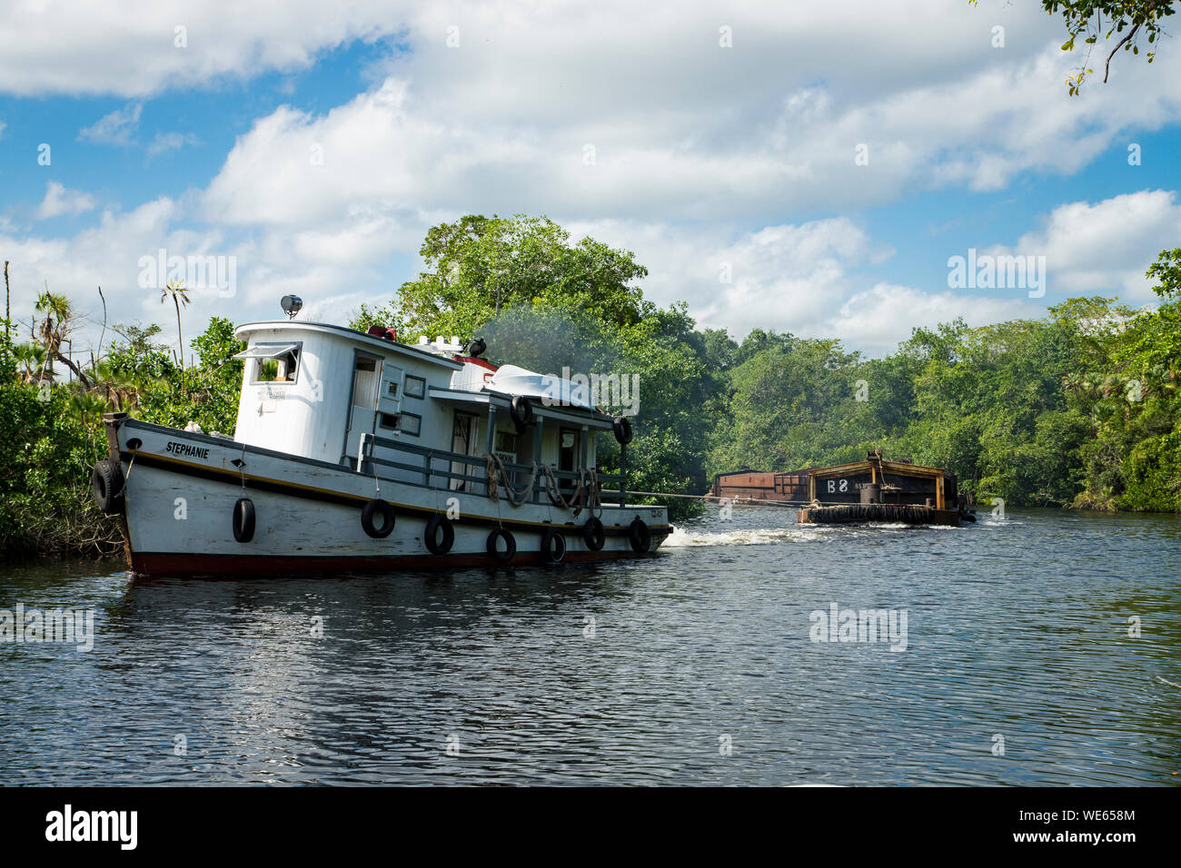 Barges sailing up the New River, Belize Stock Photo
