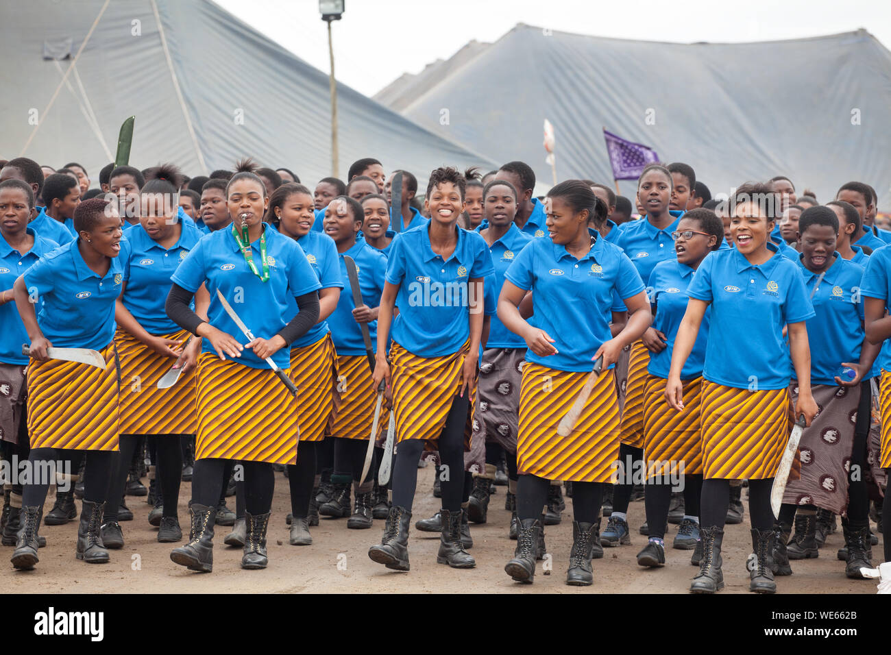 Mbabane, Swaziland - August 31, 2017: Umhlanga Reed Dance ceremony traditional rite young virgin girls with big knives machete go to field to cut reed Stock Photo