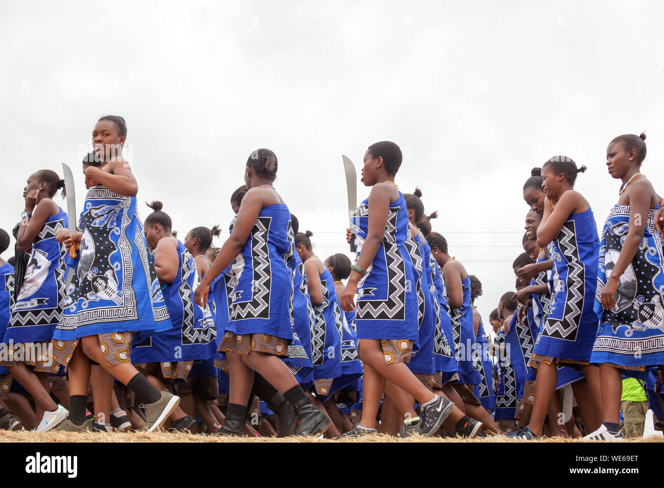 Mbabane, Swaziland - August 31, 2017: Umhlanga Reed Dance ceremony traditional rite young virgin girls with big knives machete go to field to cut reed Stock Photo