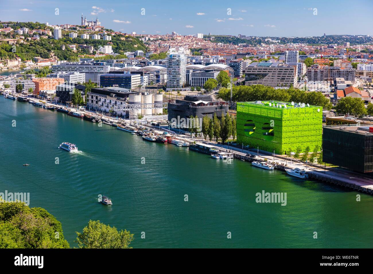 France, Rhone, Lyon, district of La Confluence in the south of the peninsula, first French quarter certified sustainable by the WWF, view of the quai Rambaud along the old docks with the Green Cube, the Sucriere, the Ycone tower and Notre Dame de Fourviere Basilica Stock Photo