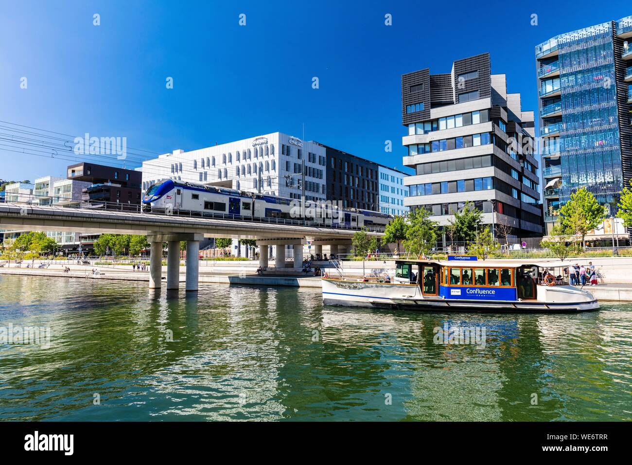 France, Rhone, Lyon, district of La Confluence in the south of the peninsula, first French quarter certified sustainable by the WWF, view on the railway and the Vaporetto Stock Photo