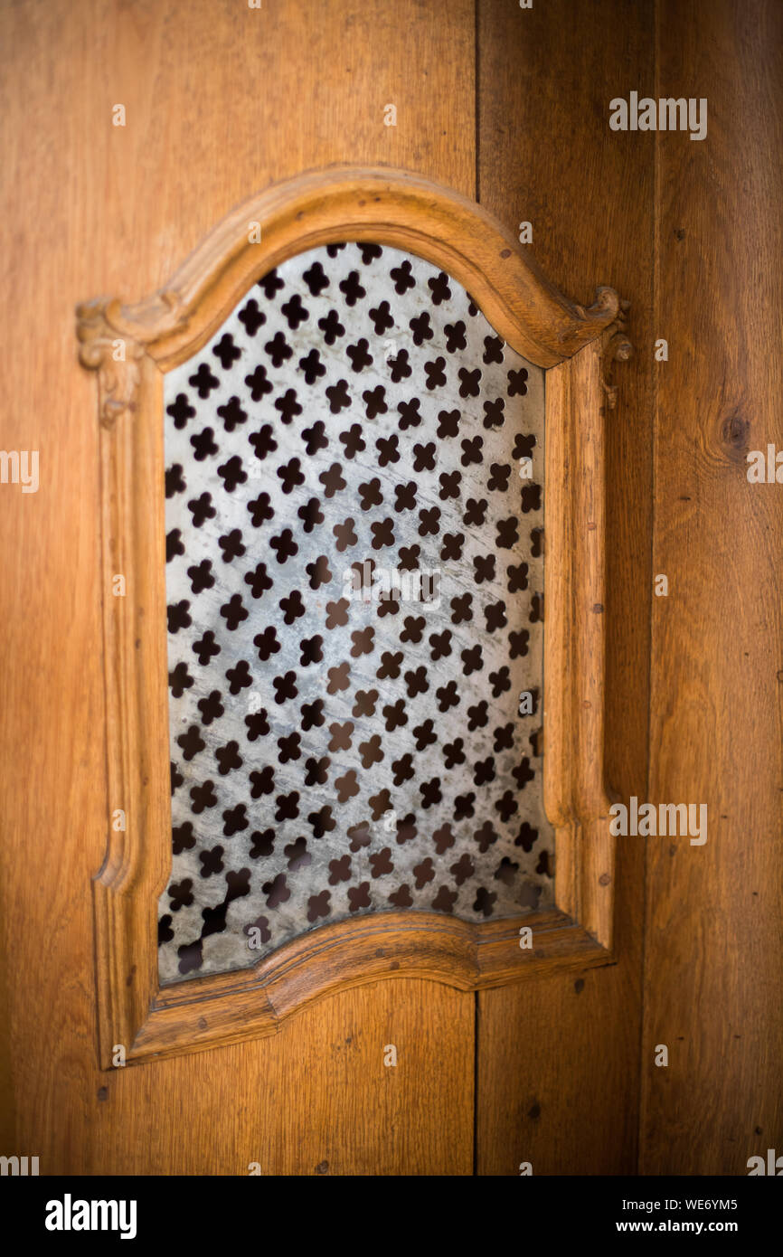 Image of a old wooden confessional in a church. Stock Photo