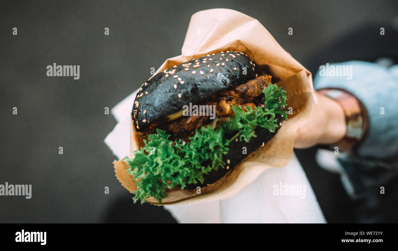 Cropped Image Of Person Holding Tofu Burger Stock Photo
