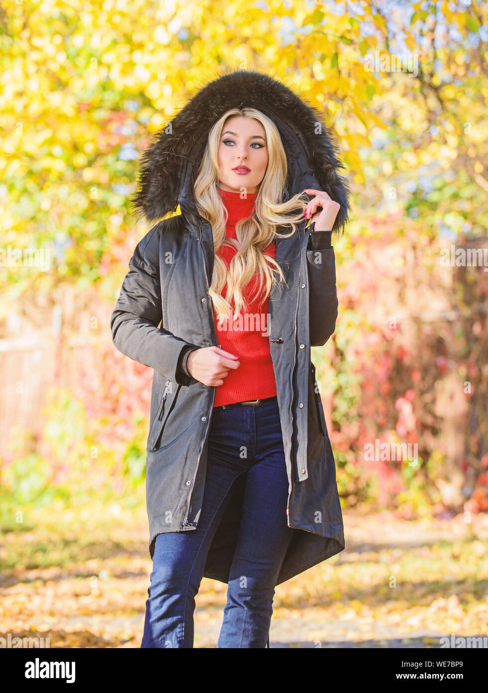 Versatile functional and stylish. Girl wear parka while walk park. Puffer  jacket with hood. Woman wear black parka fur hood. Youth hipster fashion  concept. Classic parka coat has become wardrobe icon Stock