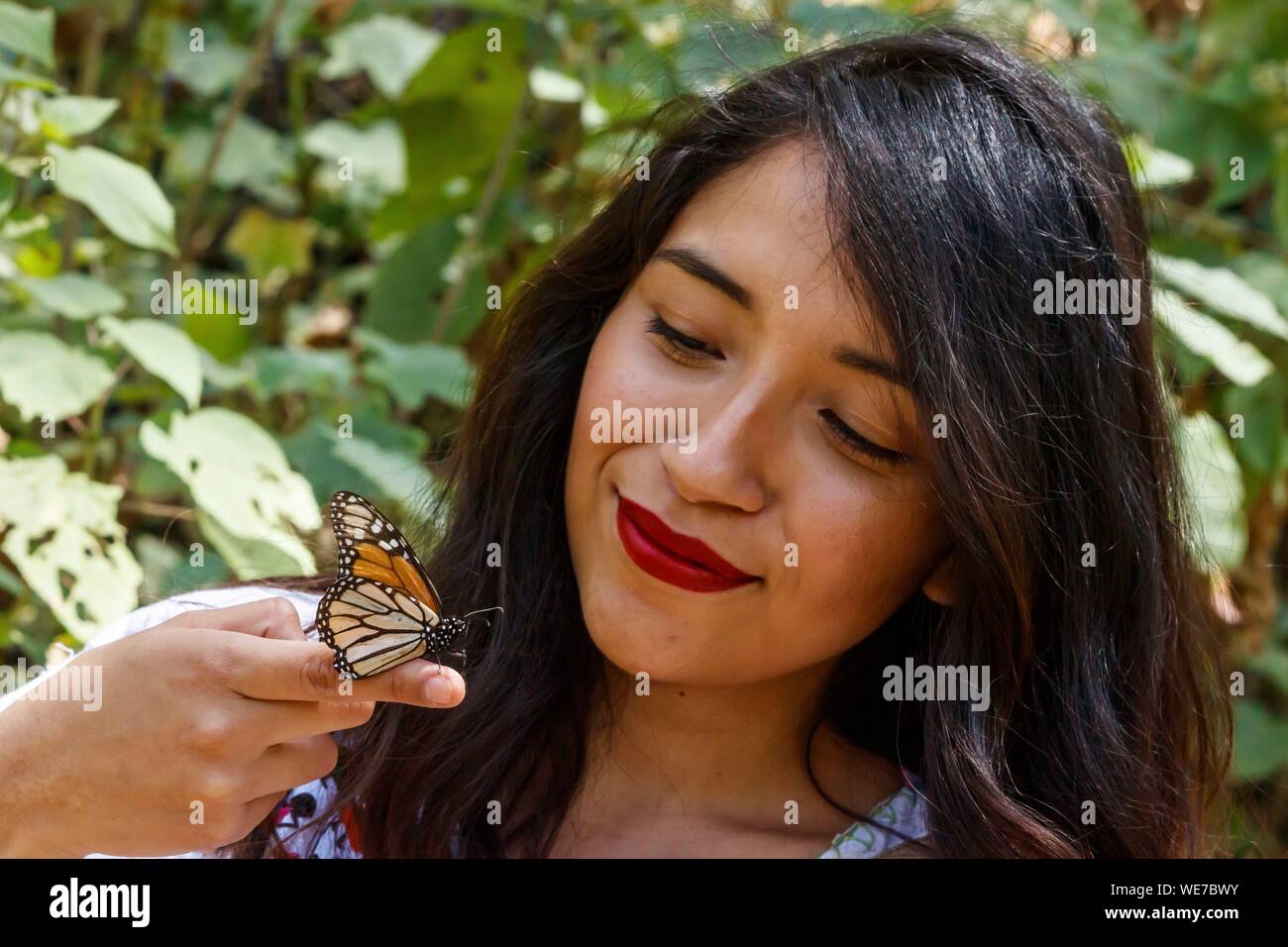 Mexico, Michoacan state, Angangueo, Unesco world heritage, Monarch Butterfly Biosphere Reserve, El Rosario, monarch butterfly on the hand of a mexican woman (Danaus plexippus) Stock Photo
