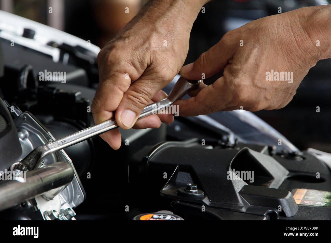 Cropped Image Of Repairman Repairing Car Stock Photo