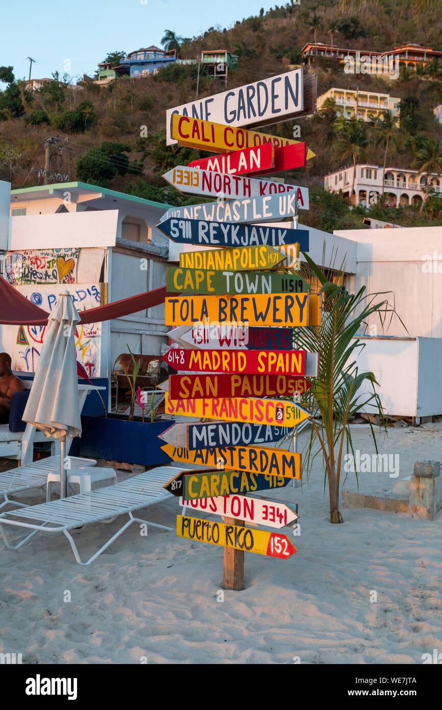 West Indies, British Virgin Islands, Tortola Island on the beach of Cane Garden Bay a signpost of different destinations in the world Stock Photo