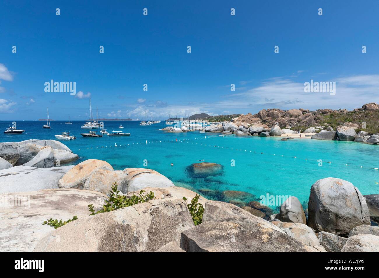 West Indies, British Virgin Islands, Virgin Gorda Island, The Baths, bathing beach view, sailboats at anchor, in the foreground the typical rocks that surround the paradisiacal swimming area Stock Photo