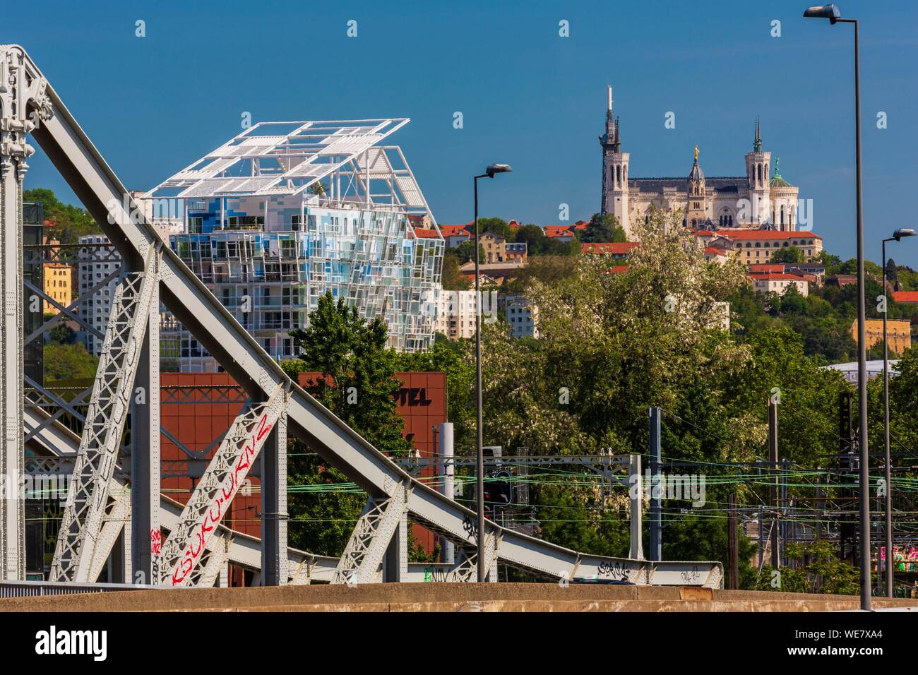 France, Rhone, Lyon, La Confluence district south of the Presqu'ile, close to the confluence of the Rhone and the Saone rivers, view of the railway and road bridge of the Mulatiere, the roof of the Ycone tower by Jean Nouvel and the basilica of Notre Dame de Fourviere Stock Photo
