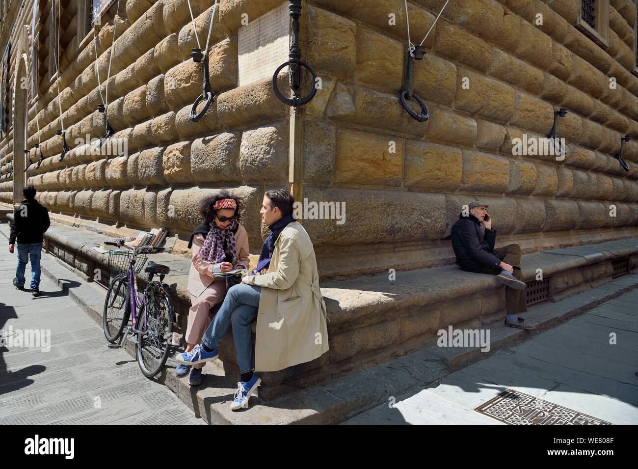 Italy, Tuscany, Florence, listed as World Heritage by UNESCO, the Renaissance palace Palazzo Strozzi, panca di via (street bench) at the foot of some prestigious Florentine palaces for the comfort of the population but also the protection of the walls against vehicles Stock Photo