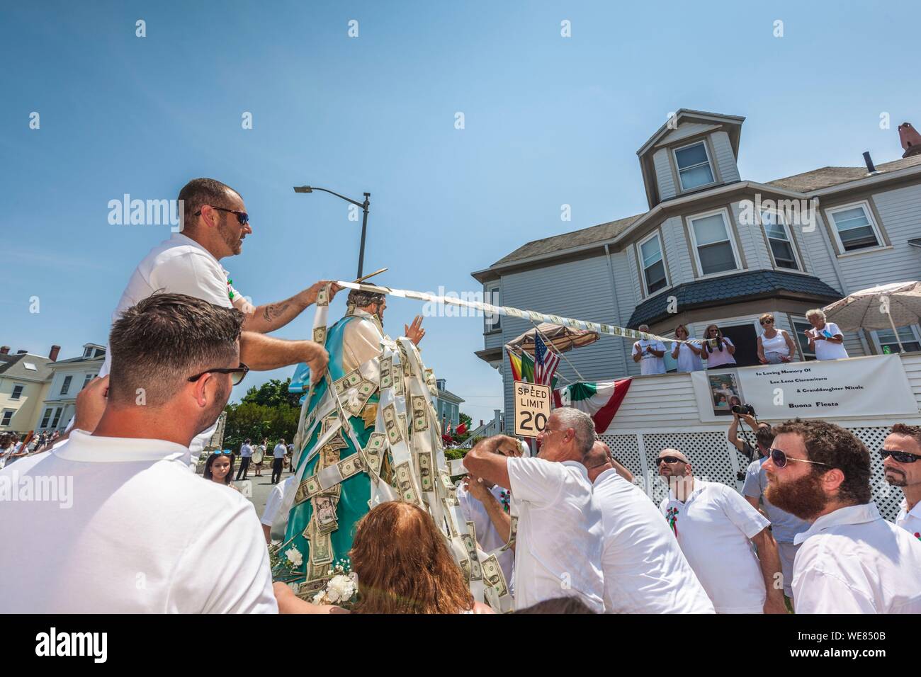 United States, New England, Massachusetts, Cape Ann, Gloucester, Saint Peters Fiesta, Traditional Italian Fishing Community Festival, men attaching ropes of money donations to the statue of St. Peter Stock Photo