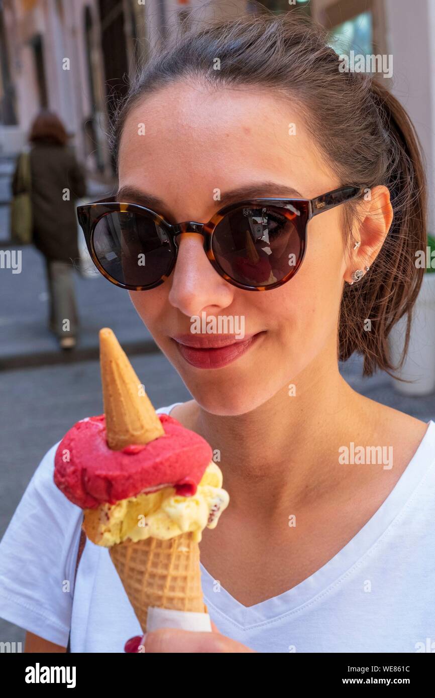 Italy, Campania, Naples, historical centre listed as World Heritage by UNESCO, young italian woman with ice cream Stock Photo
