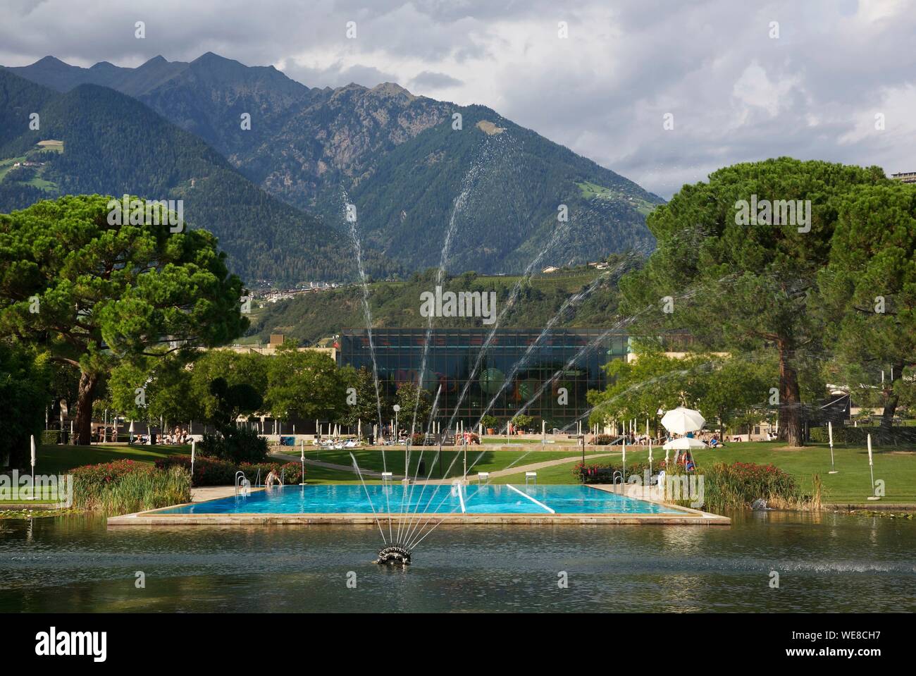 Italy, autonomous province of Bolzano, Merano, outdoor water areas and park of Merano thermal baths with mountains for decoration Stock Photo